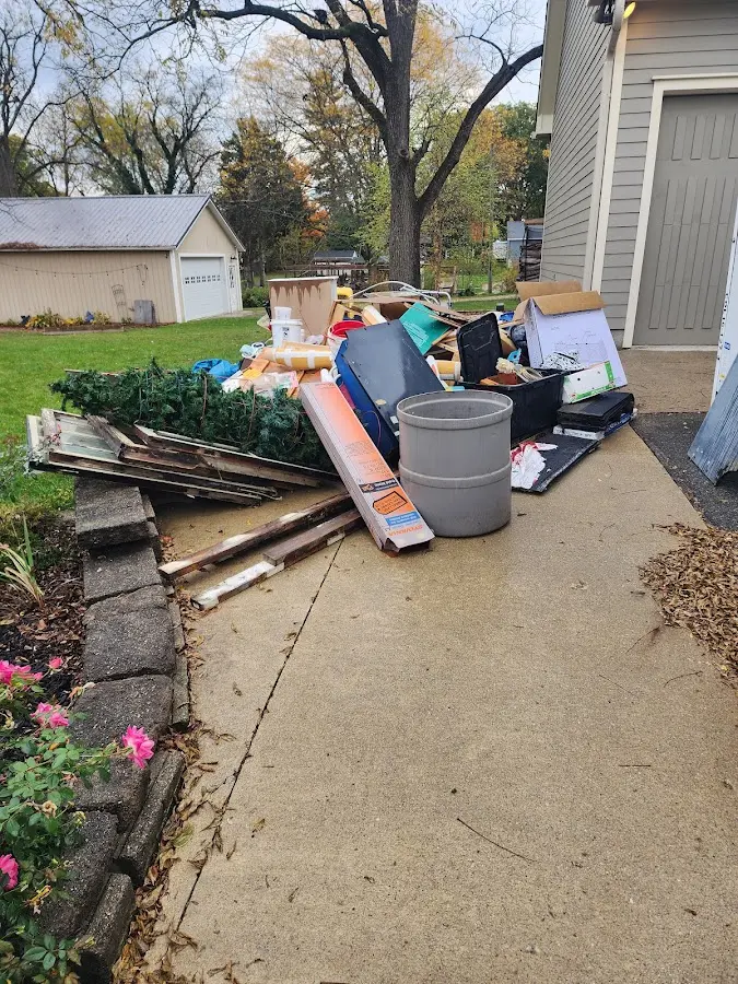 Dumpster being loaded with debris for 12 Yard Dumpster Rental in Marlboro